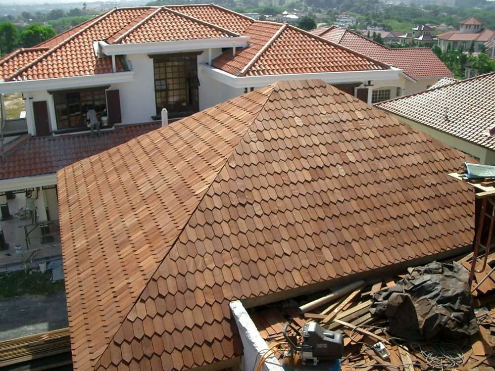 A wide-angle view of a clay tile roof replacement on a large luxury home, showing the stunning visual impact and curb appeal of clay tile roofing