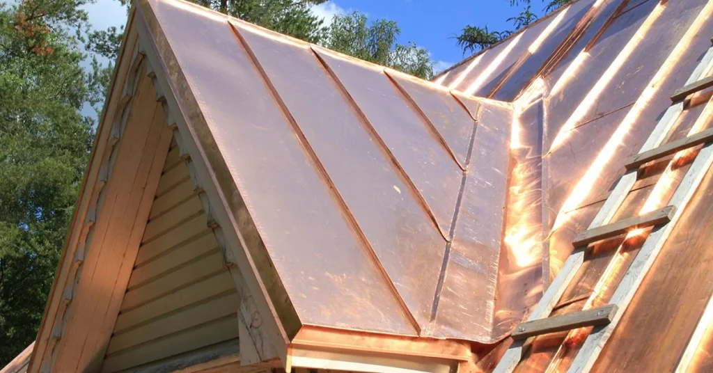 Copper roof replacement on a sloped roof, showing the durability and beauty of copper roofing