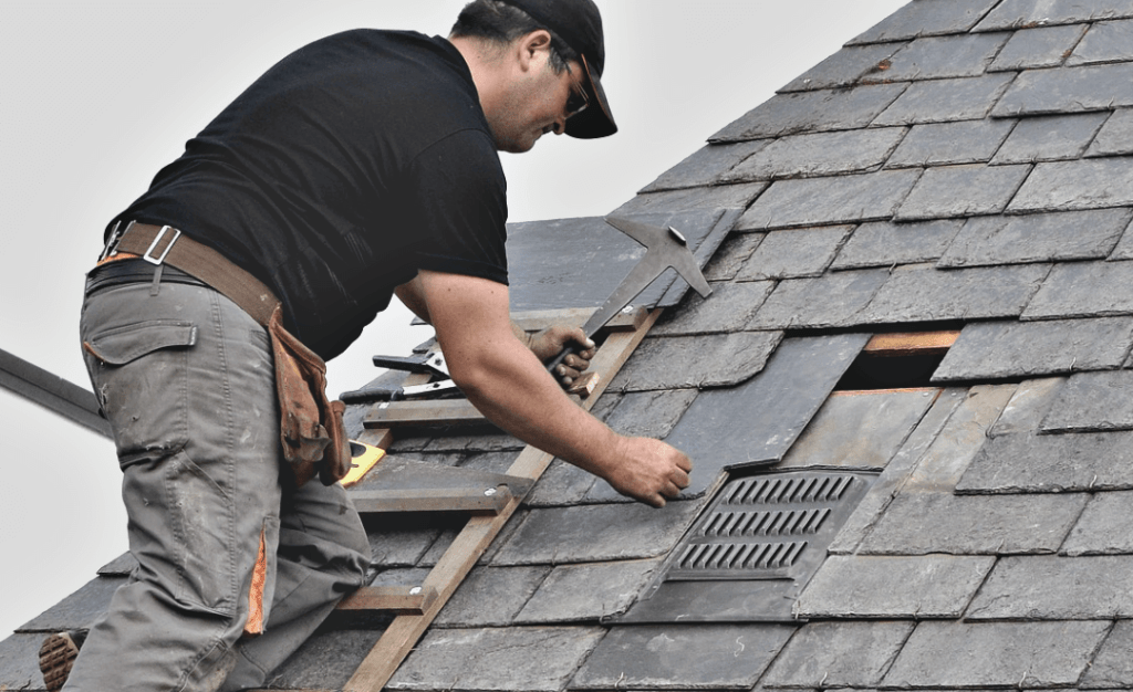 shingle roofer replacing shingles on a roof
