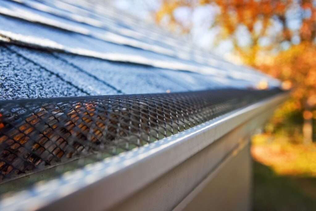 Image of gutter guards, a protective system designed to prevent debris and leaves from clogging and obstructing rain gutters on a house.