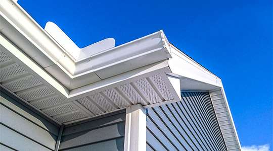 Image of a well-installed eavestrough system on a modern house, effectively managing rainwater runoff to protect the structure from water-related damage.