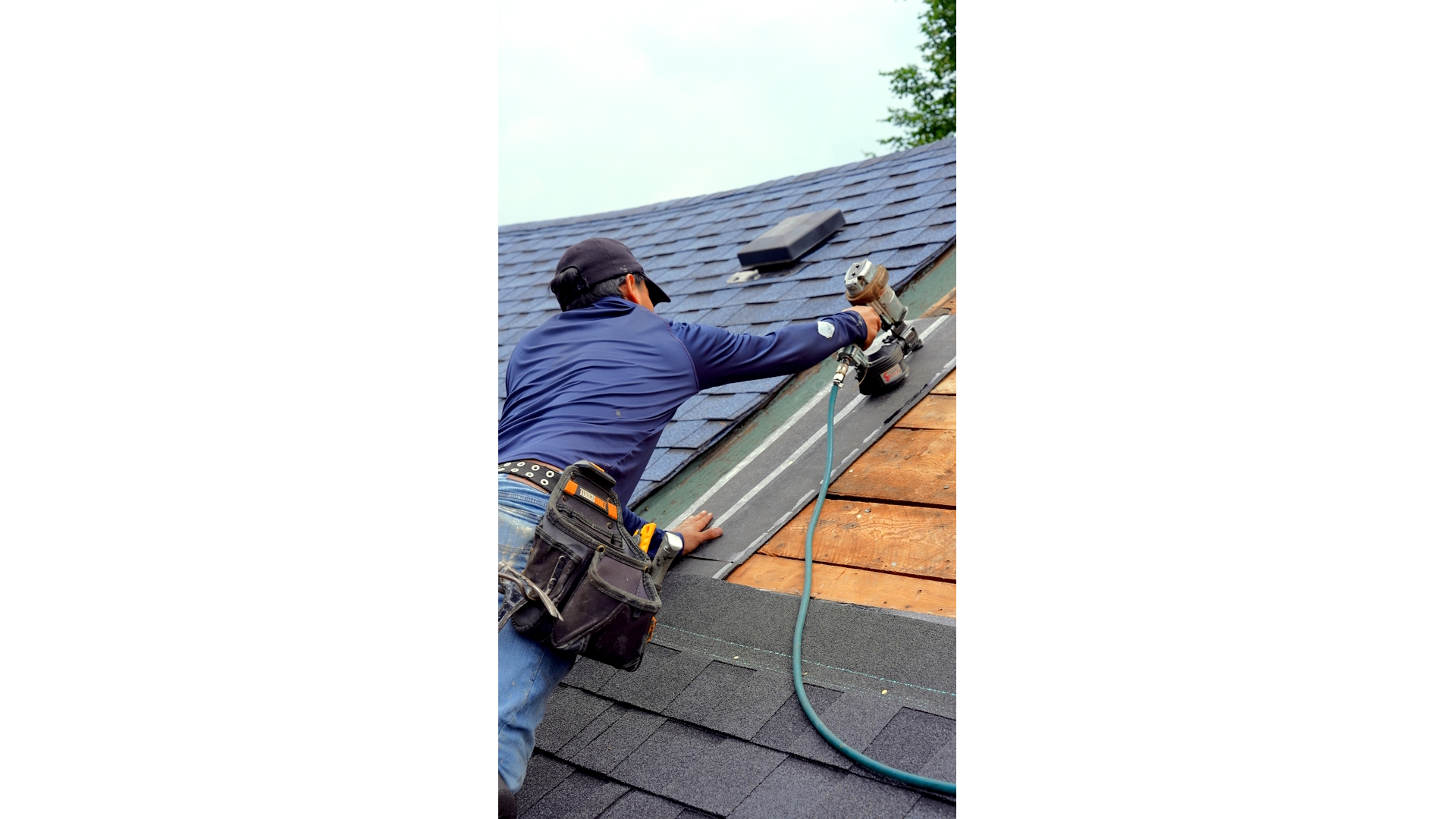 A Professional Roofers Toronto expert secures asphalt shingles on a residential roof, ensuring a durable and weather-resistant installation.